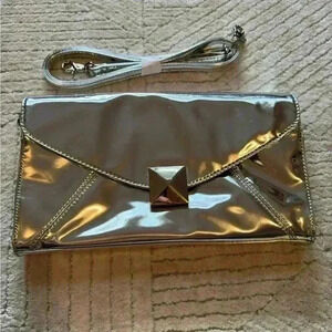 Cosmopolitan woman’s silver clutch with shoulder strap NWOT